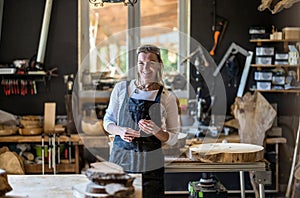 Portrait of confident craftswoman in her workshop