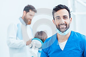 Portrait of a confident dental surgeon in a modern dental office photo