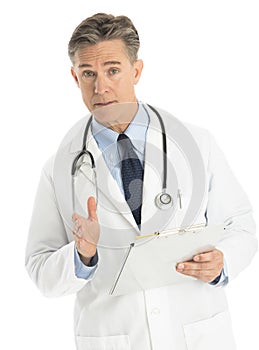 Portrait Of Confident Doctor Gesturing While Holding Clipboard