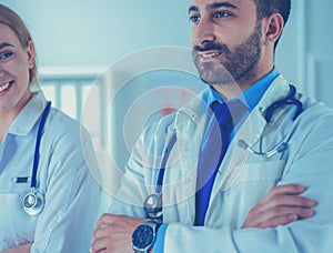 Portrait of confident doctors with arms crossed at medical office