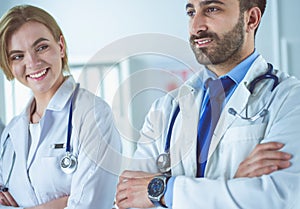 Portrait of confident doctors with arms crossed at medical office