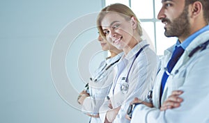 Portrait of confident doctors with arms crossed at medical office