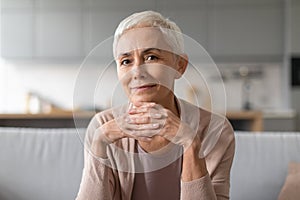 Portrait of confident european senior lady with stylish haircut indoor