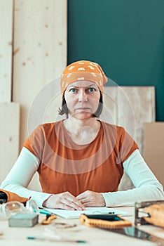Portrait of confident female carpenter wearing headscarf bandana