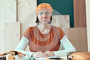 Portrait of confident female carpenter wearing headscarf bandana