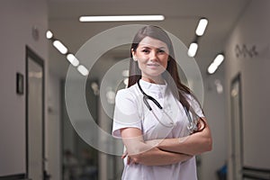 Portrait of confident female Doctor posing at camera in hospital hall