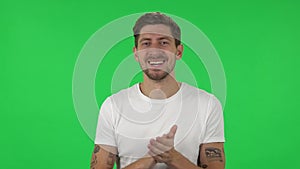 Portrait of confident guy is clapping his hands with wow happy joy and delight. Green screen