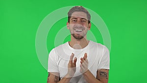 Portrait of confident guy is clapping his hands with wow happy joy and delight. Green screen