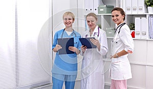 Portrait of confident happy group of doctors standing at the medical office