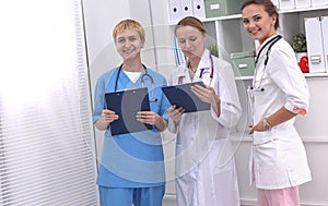 Portrait of confident happy group of doctors standing at the medical office