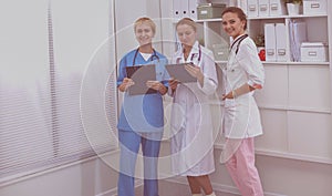 Portrait of confident happy group of doctors standing at the medical office