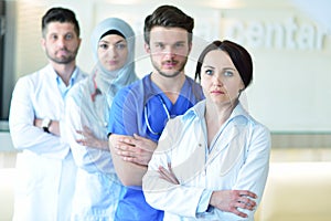 Portrait of confident happy group of doctors standing at the medical office