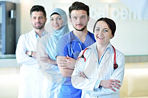 Portrait of confident happy group of doctors standing at the medical office
