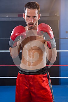 Portrait of confident male boxer in fighting stance