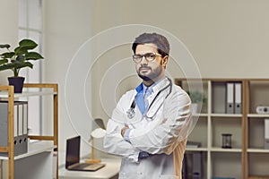 Portrait of confident male doctor standing with his arms crossed