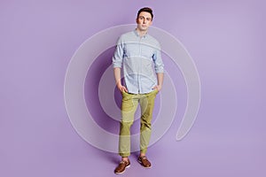 Portrait of confident manager cool guy hands pockets posing on purple background