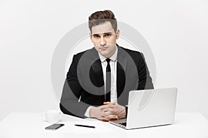 Portrait of confident manager sitting at desk and looking at camera. Portrait of business man working at computer