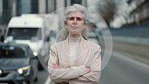 Portrait of confident mature business woman posing outdoors