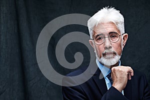 Portrait of confident mature businessman with serious face and gray hair. Good looking 60 year old man