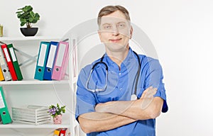 Portrait Of A Confident Mature Doctor Looking At Camera  On Medical Office Background