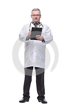 Portrait of confident mature medical doctor writing on clipboard