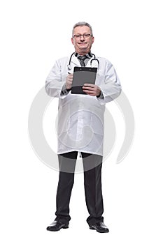 Portrait of confident mature medical doctor writing on clipboard