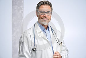 Portrait of confident mid adult medical doctor on white