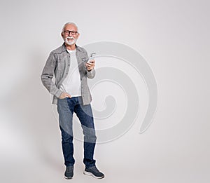 Portrait of confident old male professional with smart phone smiling at camera on white background