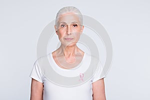 Portrait of confident person having pink ribbon wearing stylish t-shirt isolated over white background