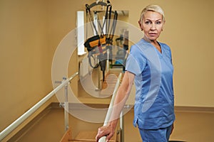 Portrait of confident physiotherapist standing in rehab center