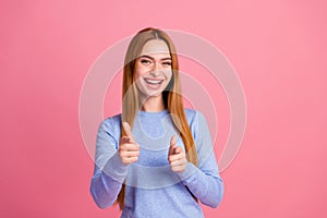 Portrait of confident pleasant girl with foxy hairdo wear blue pullover indicating at you smiling isolated on pink color