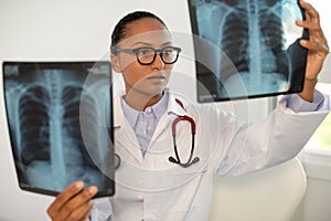 Portrait of confident pulmonologist examining x-ray of chest