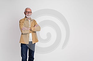 Portrait of confident senior businessman with arms crossed smiling at camera over white background