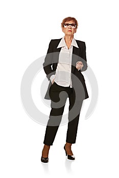 Portrait of confident senior executive manager. Stylish middle age woman in black business suit posing isolated on white