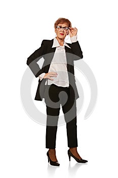 Portrait of confident senior executive manager. Stylish middle age woman in black business suit posing isolated on white