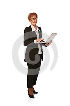 Portrait of confident senior executive manager. Stylish middle age woman in black business suit posing isolated on white