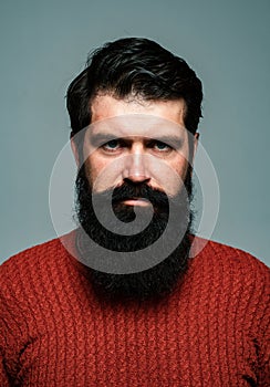 Portrait of confident serious man has beard and mustache, looks seriously, isolated. Hipster thinking with expression