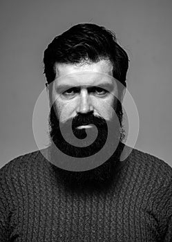 Portrait of confident serious man has beard and mustache, looks seriously, isolated. Hipster thinking with expression