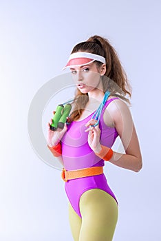 Portrait of confident sporty woman with skipping rope