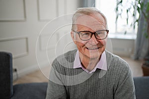 Portrait of confident stylish European middle aged senior man at home. Older mature 70s man smiling. Happy attractive