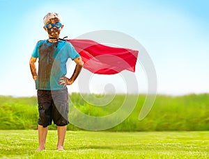 Portrait, confident and superhero kid outdoor with wind on cape, goggles and mockup on blue sky. Boy, child and hero in