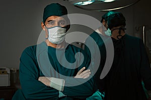 Portrait of confident surgical team leader in sterile operating room.