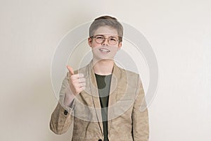 A portrait of confident  teen boy in jacket wearing eyeglasses