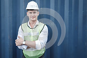 Portrait of Confident Transport Engineer Man in Safety Equipment Standing in Container Ship Yard. Transportation Engineering