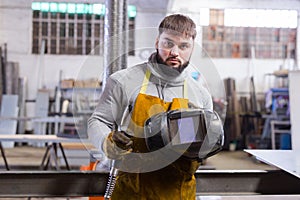 Portrait of confident welder in factory workshop