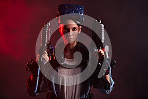 Portrait of confident woman with guns for VR game