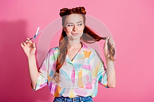 Portrait of confident woman wear print shirt look at foxy curl hold scissors making tail shorter isolated on pink color