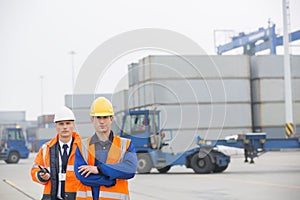 Portrait of confident workers standing in shipping yard