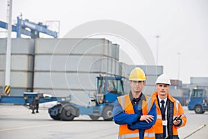 Portrait of confident workers standing in shipping yard