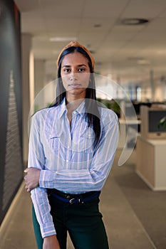 Portrait of confident young african american beautiful businesswoman standing at workplace